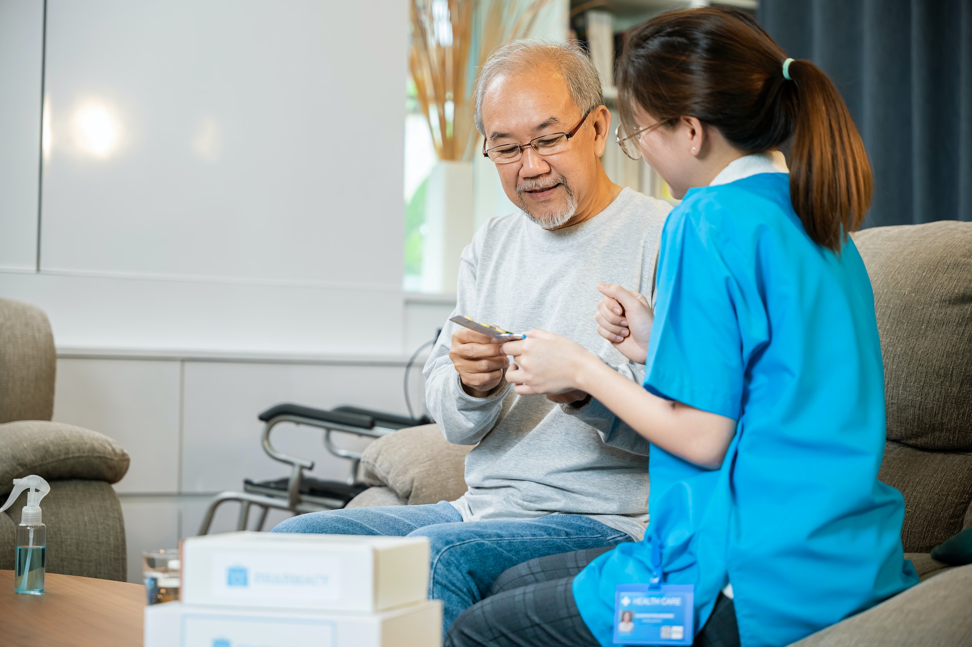 woman-nurse-caregiver-showing-prescription-drug-to-senior-man-at-nursing-home.jpg